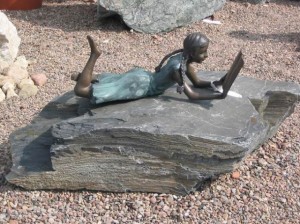 Harasimowicz ogrody - Figura z brązu - leżąca dziewczynka z  książką